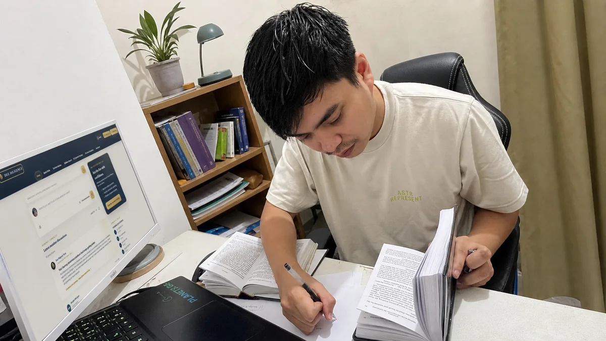 Dimasalang studying in a home law library
